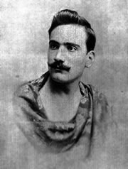 Caruso 19 years old. Since his only shirt was being washed, he draped himself in a bed-spread to receive the photographers.